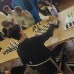Vue plongeante sur les échiquiers alignés et les joueurs installés aux championnats de l'Essonne 2021.